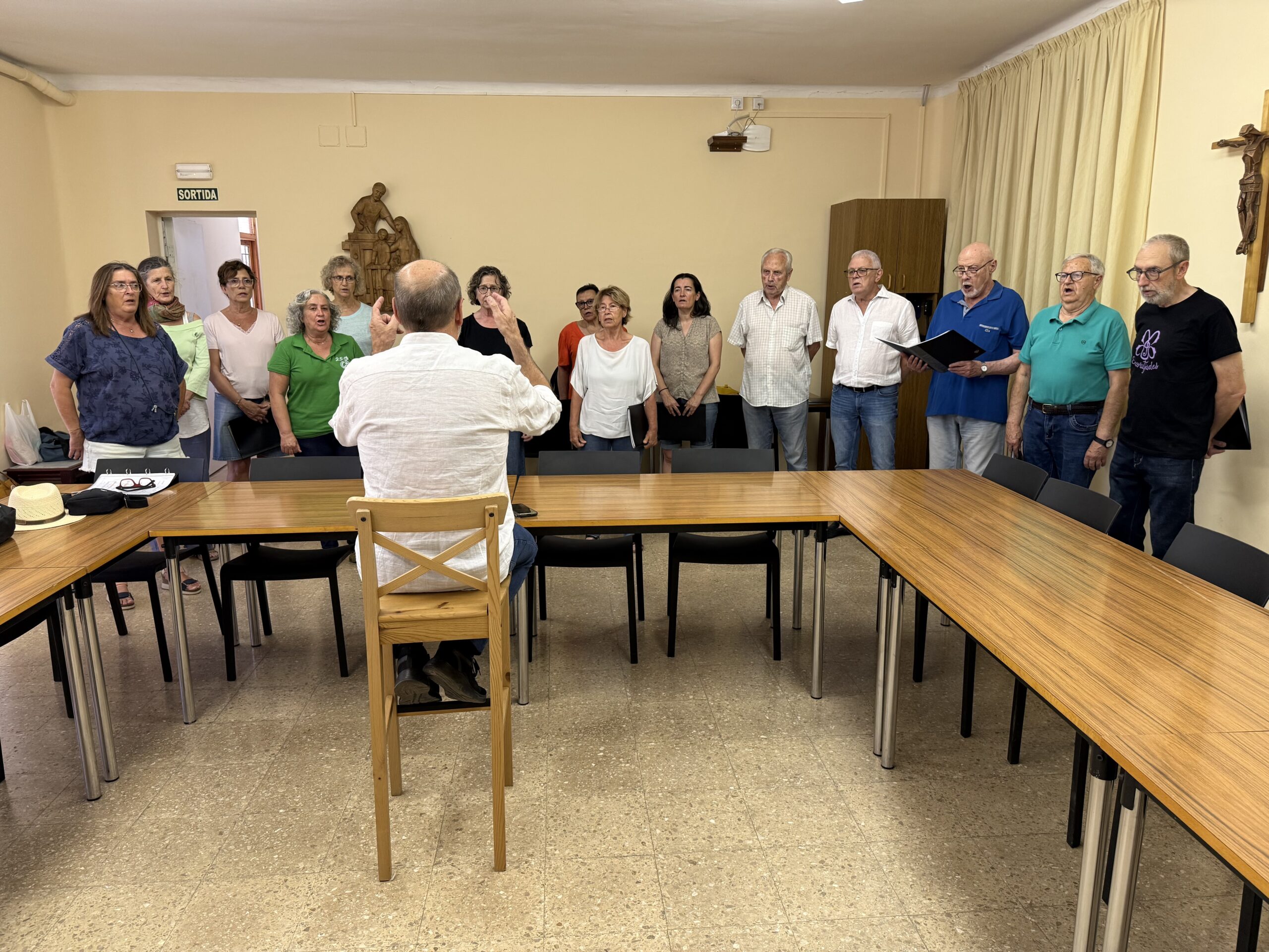 Diversos membres de la coral Signum fent un assaig en una de les sales del convent de la Sagrada Família de la Seu d'Urgell